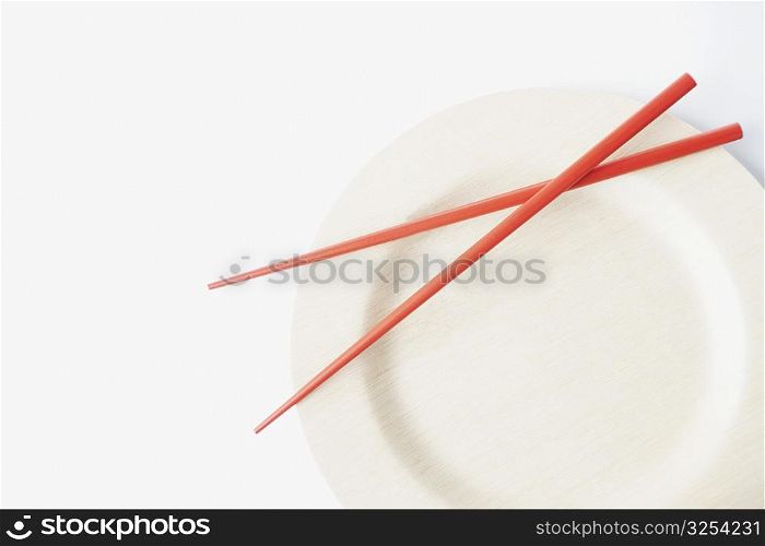 Close-up of a pair of chopsticks on a plate