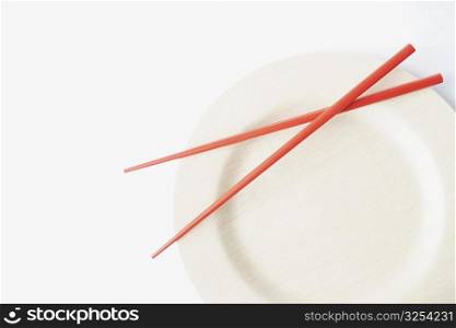Close-up of a pair of chopsticks on a plate