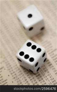 Close-up of a pair of dice on stock exchange data