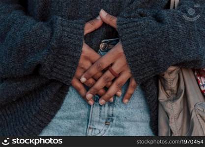 Close up of a pair of hands with a rubber ring over some mom jeans