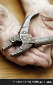 Close-up of a pair of pliers on a person&acute;s palm