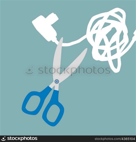 Close-up of a pair of scissor cutting the wire of an electric plug