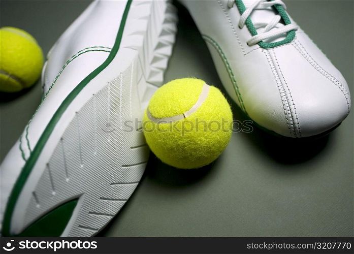 Close-up of a pair of shoes with two tennis balls