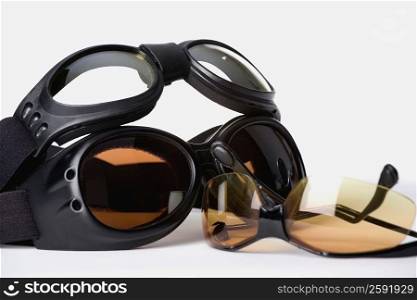 Close-up of a pair of sunglasses with two swimming goggles