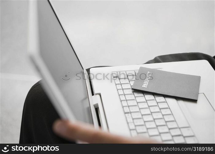Close-up of a passport on a laptop