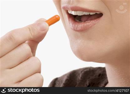 Close-up of a patient taking a capsule