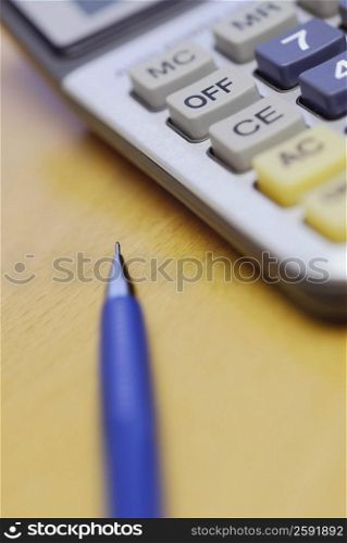 Close-up of a pen and a calculator