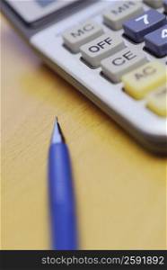 Close-up of a pen and a calculator