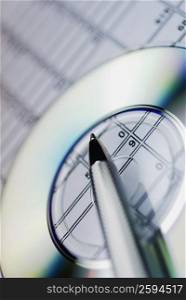 Close-up of a pen and a CD