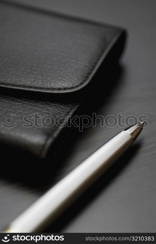 Close-up of a pen and a wallet