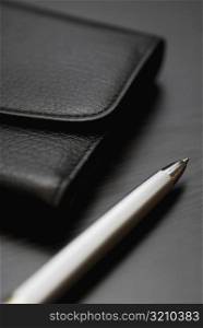 Close-up of a pen and a wallet