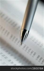 Close-up of a pen on a financial page