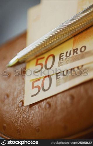 Close-up of a pen on fifty Euro banknotes