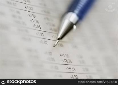 Close-up of a pen on financial figures
