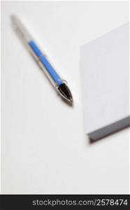 Close-up of a pen with a notepad