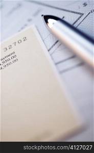 Close-up of a pen with banking documents