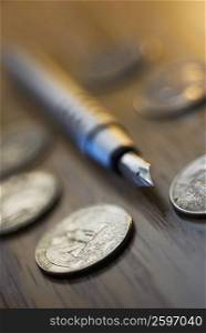 Close-up of a pen with coins