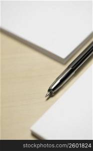 Close-up of a pen with two adhesive note pads