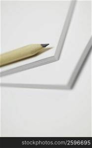 Close-up of a pencil on a notepad