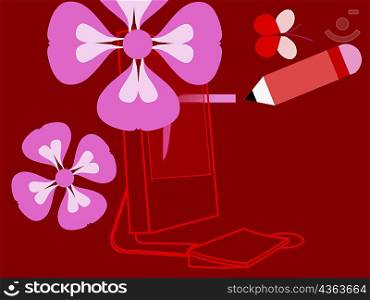 Close-up of a pencil with flowers in front of a computer