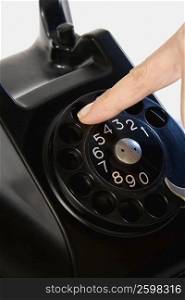 Close-up of a person&acute;s finger dialing on a telephone