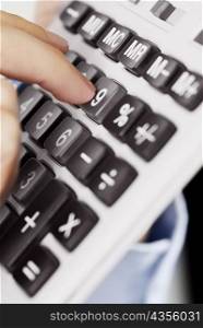 Close-up of a person&acute;s finger pressing the buttons of a calculator
