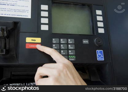 Close-up of a person&acute;s finger using a gas station machine