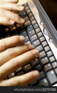 Close-up of a person&acute;s fingers using a laptop