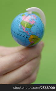 Close-up of a person&acute;s hand balancing a globe