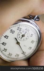 Close-up of a person&acute;s hand holding a stopwatch