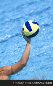 Close-up of a person&acute;s hand holding a water polo ball in a swimming pool