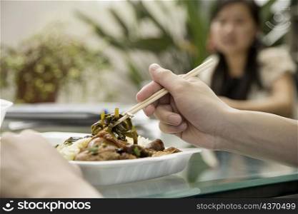 Close-up of a person&acute;s hand holding chopsticks