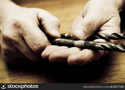 Close-up of a person&acute;s hand holding drill bits