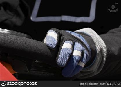 Close-up of a person&acute;s hand on the steering wheel of a racecar