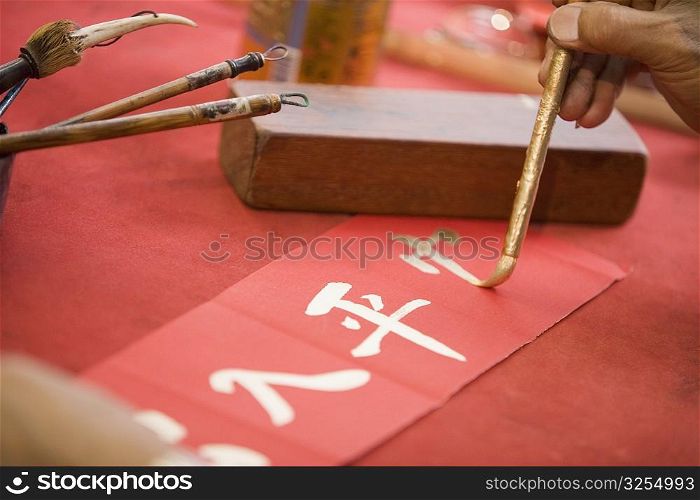 Close-up of a person&acute;s hand painting Chinese script
