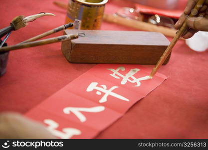 Close-up of a person&acute;s hand painting Chinese script