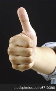 Close-up of a person&acute;s hand showing thumbs up sign