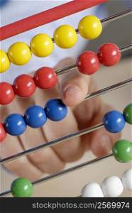 Close-up of a person&acute;s hand using an abacus