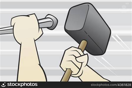 Close-up of a person&acute;s hands holding a hammer and a chisel