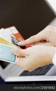 Close-up of a person&acute;s hands holding credit cards
