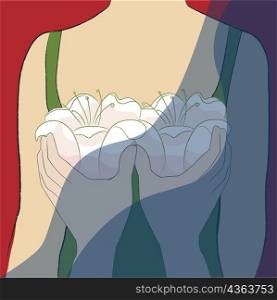 Close-up of a person&acute;s hands holding flowers in front of a woman&acute;s breast