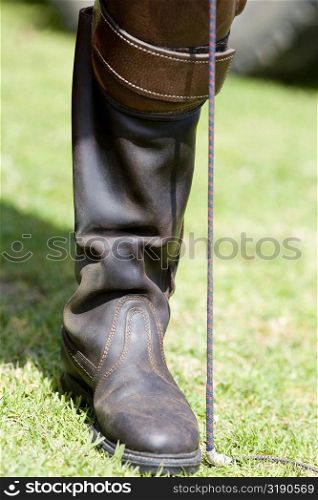 Close-up of a person&acute;s leg wearing a riding boot