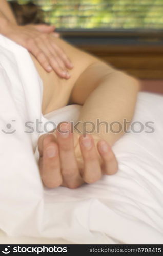 Close-up of a person getting a back massage from a massage therapist
