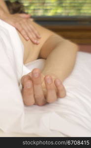 Close-up of a person getting a back massage from a massage therapist