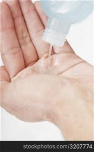 Close-up of a person pouring moisturizer