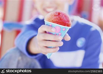 Close-up of a person showing an ice-cream cone