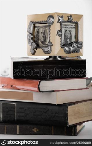 Close-up of a picture frame on a stack of books