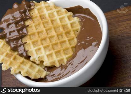 Close-up of a piece of waffle in chocolate