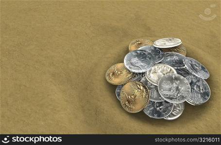Close-up of a pile of coins on sand