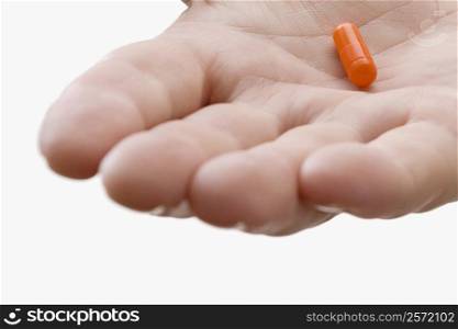 Close-up of a pill on a doctor&acute;s palm